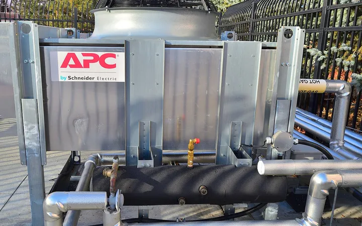 Outdoor data-center cooling equipment with pipes and a fan.