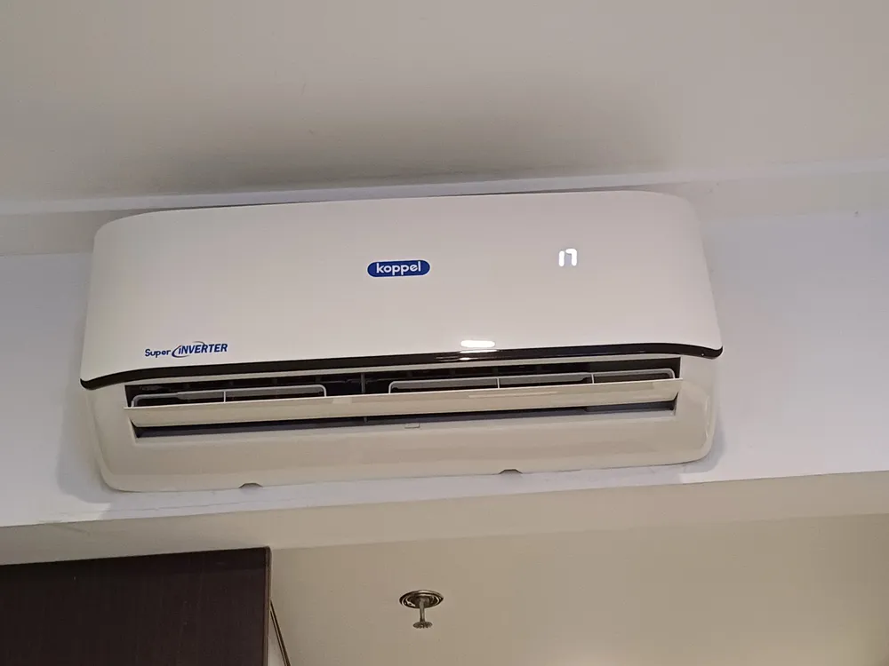 A wall-mounted split air conditioner in a hotel room.