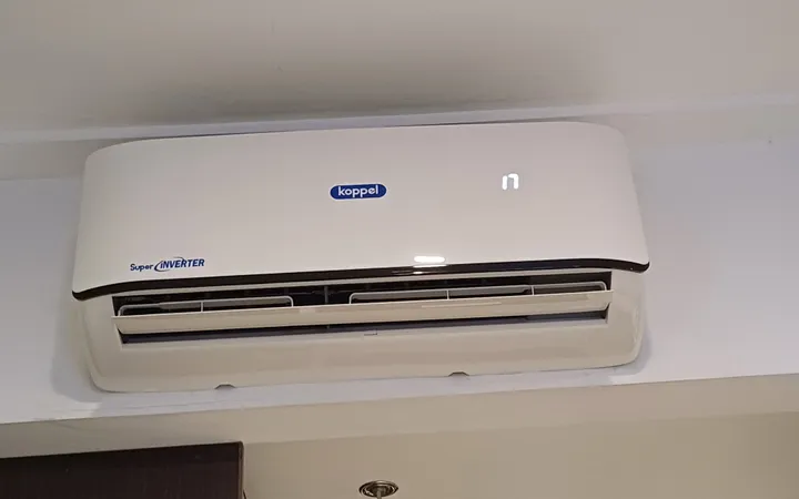 A wall-mounted split air conditioner in a hotel room.